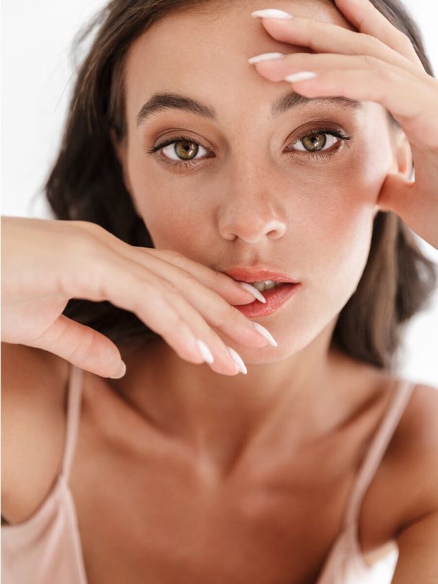 Model with natural makeup and stylish pose.